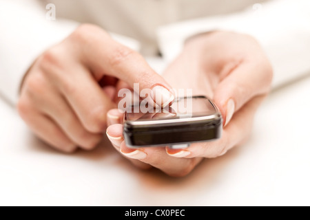 Closeup of female hands using a smart phone. Stock Photo