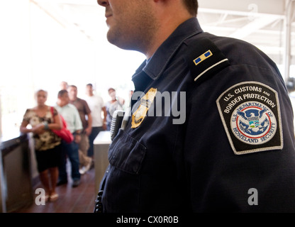U.S. Customs and Border Protection officers check the credentials of ...