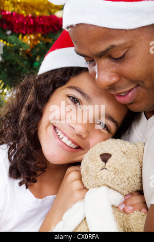 happy daughter hugging daddy with Christmas gift Stock Photo