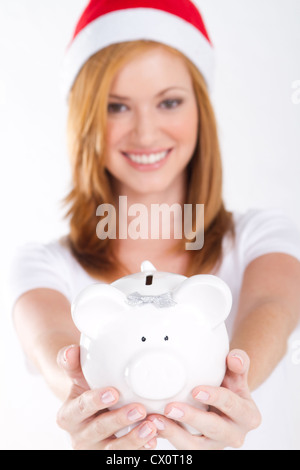 christmas girl with piggy bank on white Stock Photo