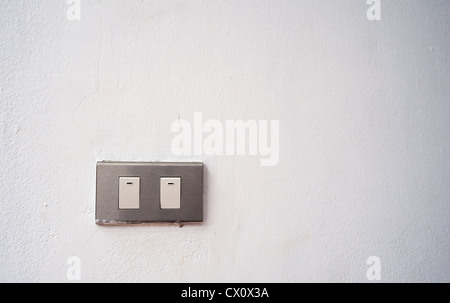 Old power switch on white wall texture Stock Photo