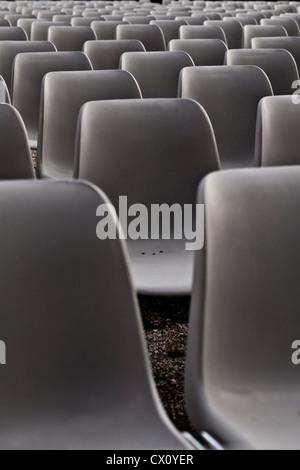 rows of grey plastic chairs Stock Photo