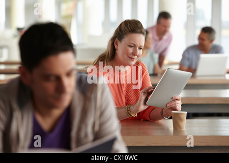 Woman using digital tablet in class Stock Photo