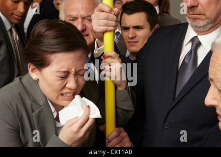 Businesswoman sneezing on subway train Stock Photo