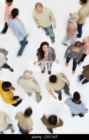 Woman standing in crowd of people, high angle view Stock Photo