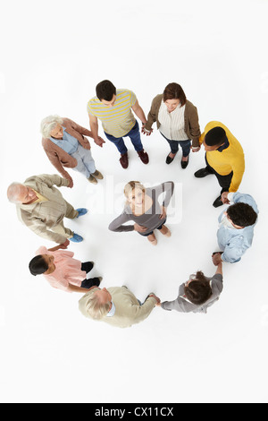 Group of people in a circle with woman in the middle, high angle view Stock Photo