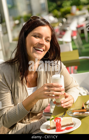 Woman at cafe bar holding latte drink smiling happy coffee Stock Photo