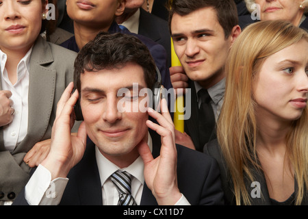 Businesswoman wearing headphones on subway train Stock Photo