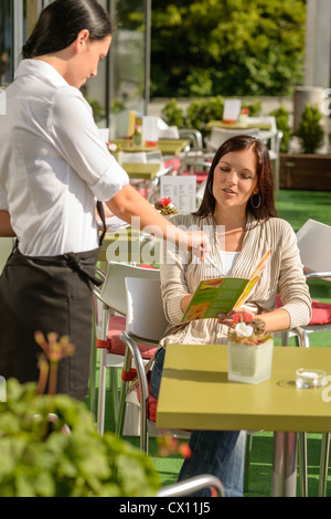 Waitress point menu woman in cafe bar terrace order food Stock Photo