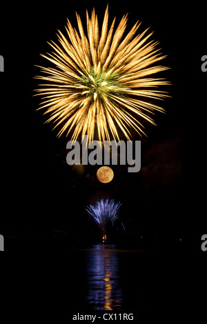 Firework in the sky above the moon Stock Photo