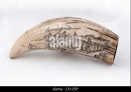 Whale tooth scrimshaw with pictorial etching of men inspecting barrels before voyage (probably a replica). Stock Photo