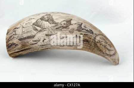 Whale tooth scrimshaw etched with whaling ships hunting and a volcano erupting on Fogos island, Cape Verde (probably a replica) Stock Photo