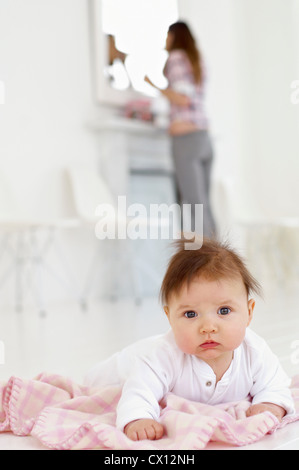 Baby girl with mother in background Stock Photo
