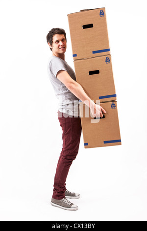 Moving, symbol image. Young man is carrying moving boxes. Stock Photo