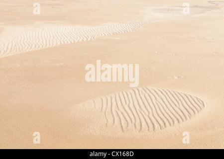 Ripples in sand creating patterns on the beach, England, UK Stock Photo