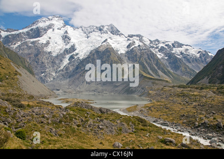 Glacial water flowing off the Hooker and Mueller glaciers join forces near Mount Cook village, with Mount Sefton dominating afar Stock Photo