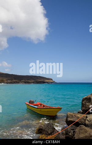 Colourful fishing boat tied up in the entrance to the bay of Anakena Beach, Easter Island, Chile. Stock Photo