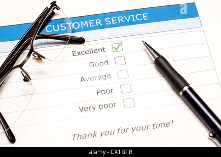 Excellent checkbox on customer service satisfaction survey with keyboard and mouse Stock Photo