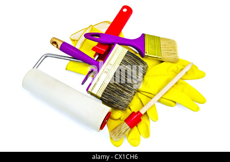 Brushes of various sizes with yellow gloves and roller isolated on white background Stock Photo