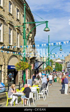 People at a cafe on the main shopping street Buxton Spa Town centre Derbyshire Peak District England UK GB EU Europe Stock Photo