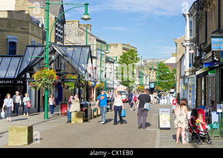 People walking on the main shopping street Buxton Spa Town centre Derbyshire Peak Disctrict England UK GB EU Europe Stock Photo