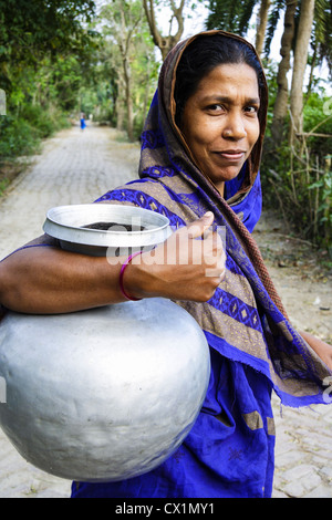 Portrait of woman with sari carrying water pitcher in Bagerhat , Bangladesh Stock Photo