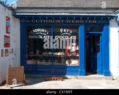 Replica of a Victorian Grocers shop with advertising for Fry's and Cadbury's chocolate on the window Stock Photo