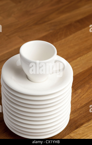 Coffee cup on the stack of saucers. Stock Photo