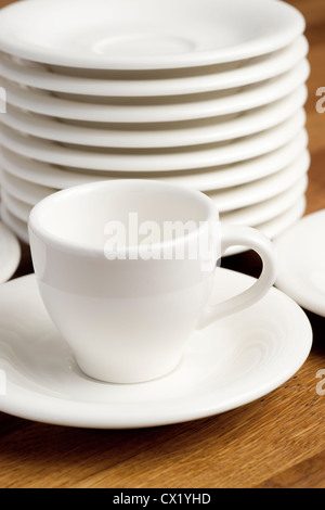 Coffee cup and the stack of saucers. Stock Photo