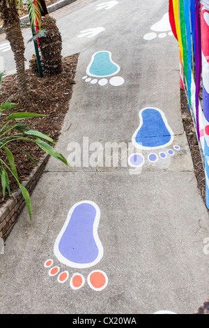 Walking path with painted feet at the Big Pineapple Tourist attraction on Queensland's Sunshine Coast. Stock Photo