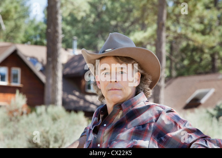 Close-up portrait of a mature man wearing cowboy hat Stock Photo