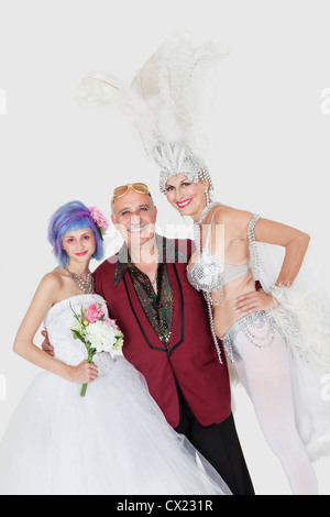 Portrait of man with senior showgirl and daughter in wedding dress over gray background Stock Photo