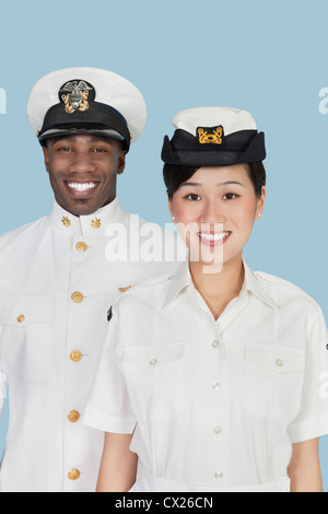 Portrait of multi-ethnic US Navy officers smiling over light blue background Stock Photo