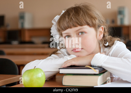 Schoolgirl's portrait at school desk with her books Stock Photo - Alamy