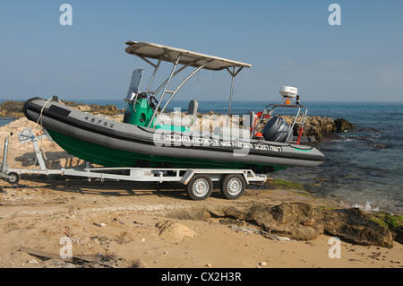 A RIB (Rigid hulled) inflatable boat is lowered into the Mediterranean sea Stock Photo