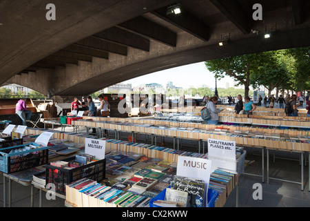 Second hand book stall under Waterloo bridge on the south bank of the Thames in London. Stock Photo