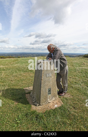 Man reading the information on the stone plinth at the top of Ditchling Beacon, East Sussex. Stock Photo