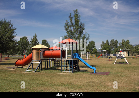 Children's school playground with swings and slide the blue Stock Photo
