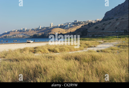 The shore of lake Kinneret near the town of Tiberias in the summer at sunset Stock Photo