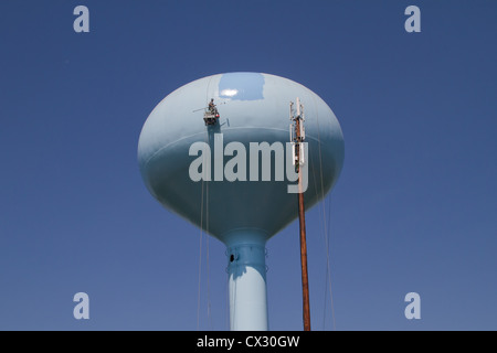 Water tower being repaired and painted Stock Photo