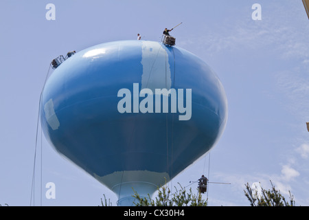 Water tower being repaired and painted Stock Photo