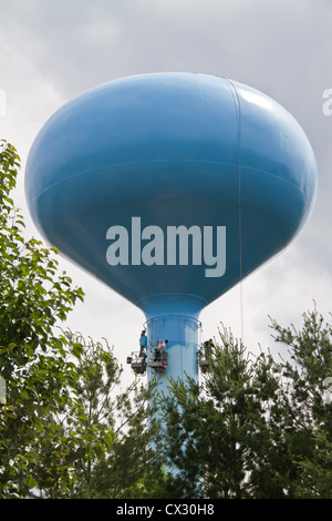 Water tower being repaired and painted Stock Photo