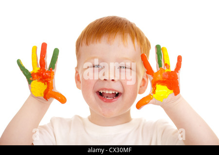 Adorable red-haired boy with hands painted in bright colors isolated on white Stock Photo