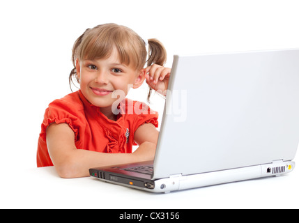 smiling schoolgirl sitting at notebook looking directly to camera isolated on white Stock Photo