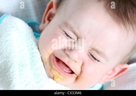 Crying baby boy eating vegetable mash Stock Photo