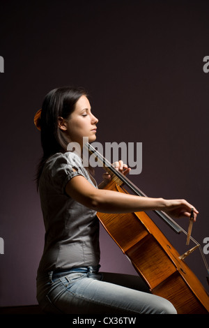 Passionate real artist, young woman playing her classical instrument. Stock Photo