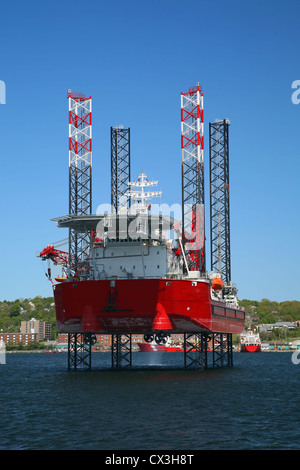 Ocean going jack up rig in Halifax Harbor, Nova Scotia, Canada. Dartmouth can be seen along the shoreline. Stock Photo