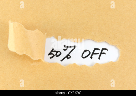 Torn paper with fifty percent off words behind it Stock Photo