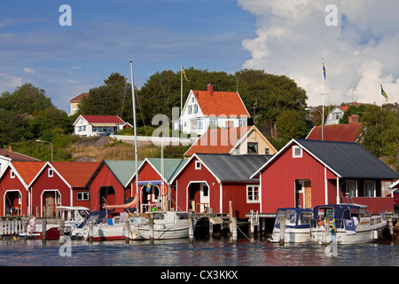 Red wooden boat huts in the harbour at Hamburgsund, Bohuslän, Sweden Stock Photo