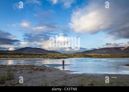 A man fishes in the Noatak River in Noatak National Preserve, Alaska, USA. Stock Photo